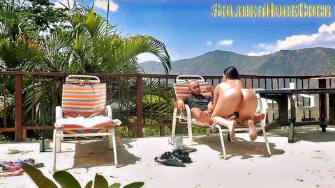 Latina woman rides man reverse cowgirl outdoors, recorded for wife