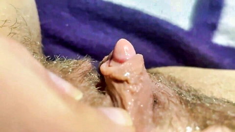 Close-up of large aroused clitoris during lesbian orgasm, hand stimulation