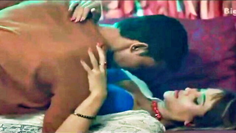 Indian couple in passionate embrace, man kissing woman's neck on bed in Hindi web series