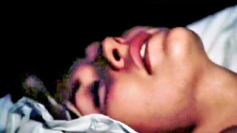 Close-up of sensual Asian woman with ecstatic expression in lesbian domination scene