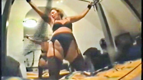 Bound blonde German MILF in black lingerie and stockings, ready for whipping