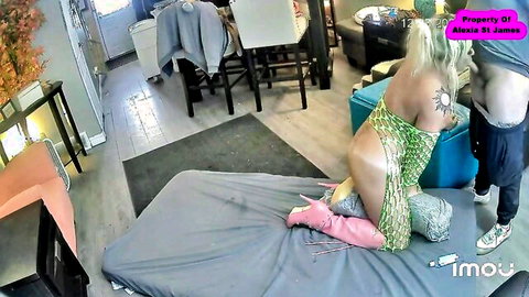 Blonde sissy in green mesh lingerie kneels doggy style on bed as man exposes ass and cock for rough anal fuck