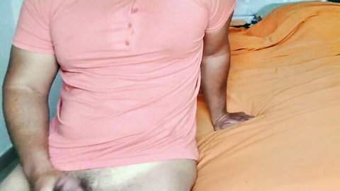 Fit Latino man masturbating solo in pink polo shirt