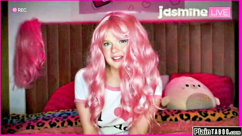 Coco Lovelock as pink-haired streamer in white top, teasing smile in bedroom live