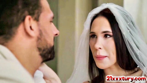 Alyssa Bounty in wedding veil sharing intimate gaze with bearded lover