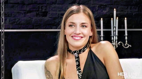 Silvia Dellai smiling in sexy black dress and choker necklace