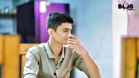 Young Indian man in casual shirt sipping tea, from Sexy Madam web series with Zoya Rathore
