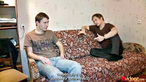 Two young Caucasian men in casual clothes discussing money in amateur gay video