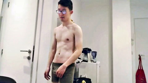 Slim Asian emo guy shirtless in shorts, toned abs visible