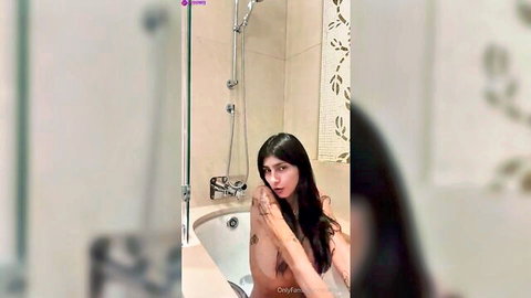 Young curvy olive brunette with big tits poses topless in steamy bathroom webcam