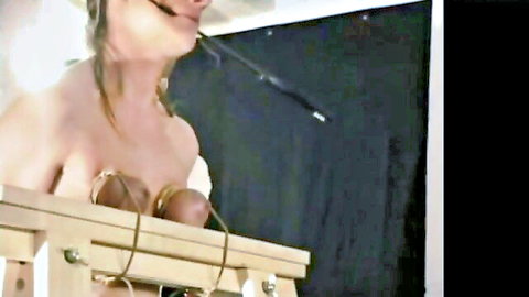 Blonde in tight breast bondage torture on frame, topless with ropes