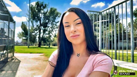 Cara Mella in low-cut pink top, smiling outdoor POV tease
