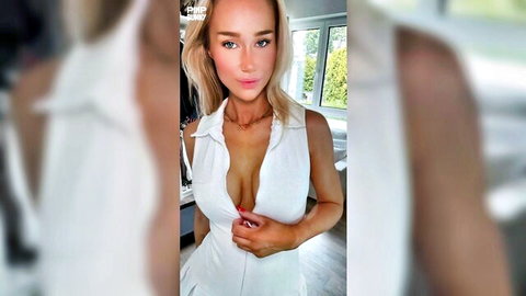 Blonde bombshell teasing in unbuttoned white dress showing deep cleavage