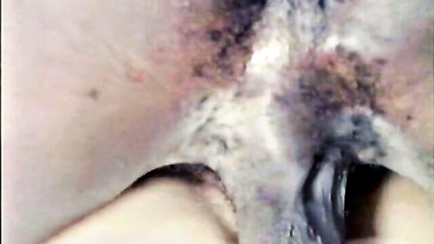 Retro close-up of black woman's ass with toy insertion