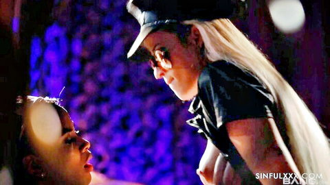 Blonde policewoman in sexy uniform with cleavage, close to brunette rookie officer