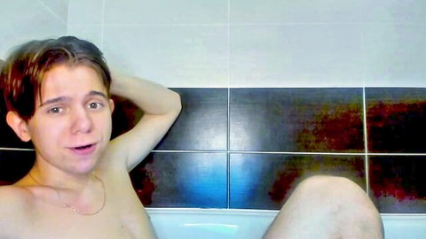 Luxallenn young slim man nude in bathtub, surprised expression