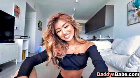 Smiling Asian teen in black off-shoulder top, daddy's babe tease
