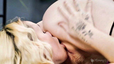 Blonde woman in lingerie kissing bearded man's neck intimately