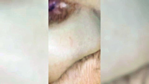 Close-up of woman's seductive eye with purple eyeshadow and lashes