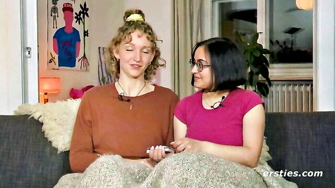 Jasmina and Serafina cuddling on couch playing with sex toys