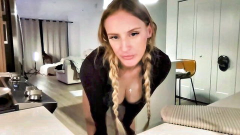 Fallanajones blonde camgirl with big boobs leaning forward in black top