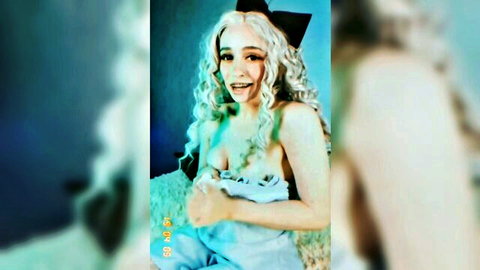 Alice Bong in Alice cosplay, topless in blue dress at home, smiling seductively