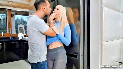 Roxy Risingstar passionately kissing muscular man in blue sweater and leggings