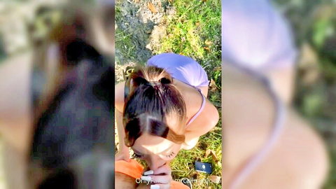 Call Me Slo in purple swimsuit kneeling in woods, outdoor tease
