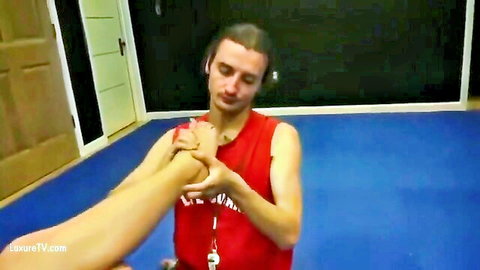 Femdom woman in dress dominates kneeling lifeguard man holding her foot