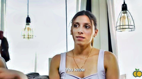 Brunette woman in tank top with knowing look, adult video thumbnail