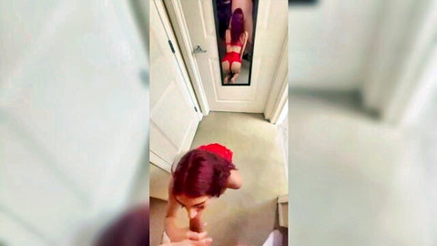 Redhead in red thong lingerie poses sexy in mirror, ComicCon style