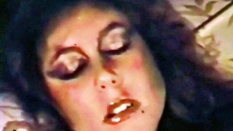 Closeup of brunette MILF's ecstatic orgasm face with heavy retro makeup and glossy parted lips