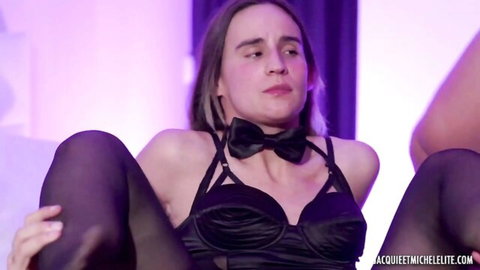 Brunette in black bowtie lingerie harness spreads legs wide exposing perky tits