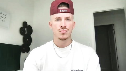 Travis Tops handsome gay dom in white shirt and red Angels cap