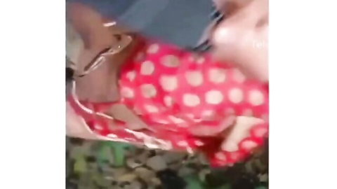 Indian woman in pink polka dot lingerie lounging in jungle outdoors