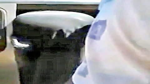 Egyptian woman in blue outfit teasing on black seat in car, white accents