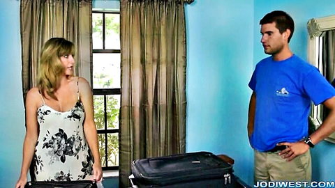 Jodi West blonde MILF in floral tank top with handsome guy and suitcase