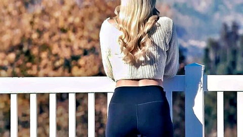 Blonde babe in tight black leggings showing off her perfect round ass on outdoor balcony