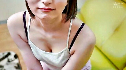 Asian woman with short hair in low-cut white top showing cleavage