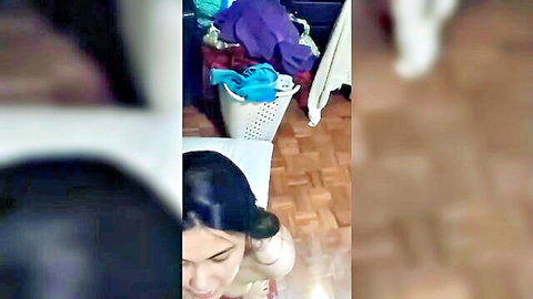 Sexy Pinay woman teasing in laundry room, dark hair and smiling face