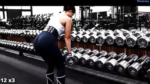 Curvy Latina bending over in tight blue leggings during intense leg day gym workout
