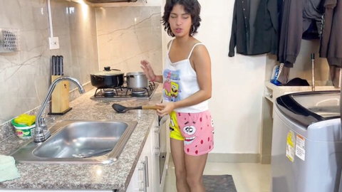 Latina stepsister teasing in kitchen wearing SpongeBob tank top and shorts