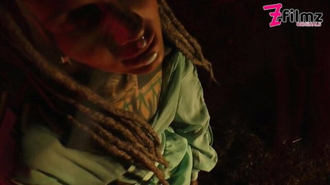Anuskatzz close-up portrait with dreadlocks in green top, ZFilmz fetish video with Lily Lou