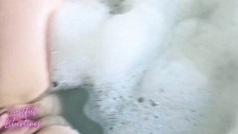 Lustful Libertines in bubbly bath, lifting legs teasingly
