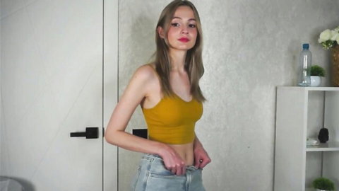 Esmeblond young blonde teen camgirl in yellow crop top and jeans, teasing pose