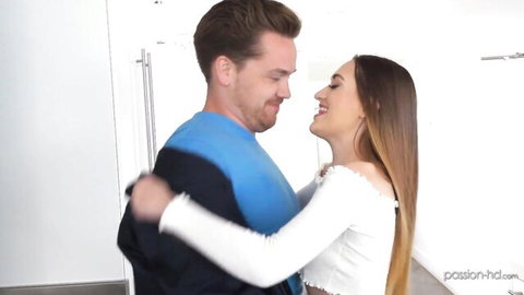 Handsome handyman in blue shirt embraces smiling brunette in white top