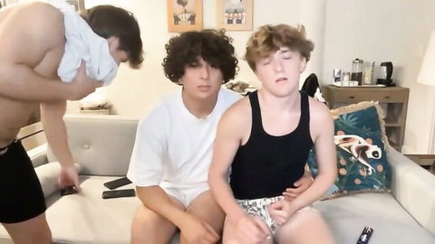 Three young gay twinks in underwear tease on couch with muscular guy grabbing face