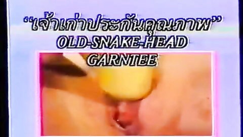 Glitchy Thai adult video thumbnail with distorted yellow-green imagery and Old Snake Head text