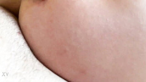 Close-up of pale hairy MILF's neck and shoulder in erotic video