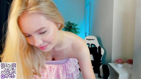 Melanie Ryer shy blonde 18yo in pink top, teasing cleavage on Chaturbate